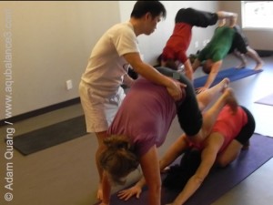 Adam Adjusting parner yoga down ward facing dog-Virgin Yoga Workshop